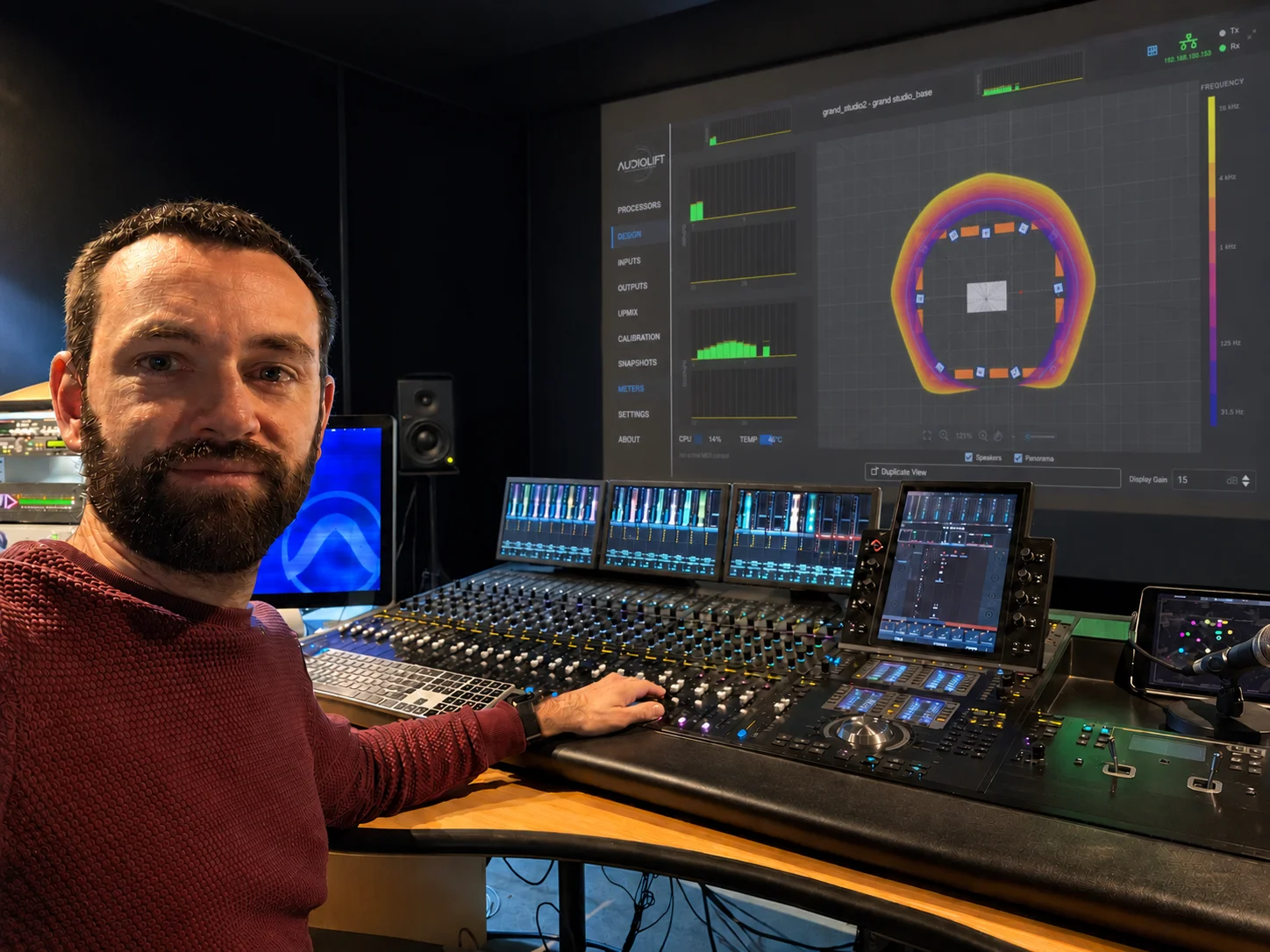 Damien Jacquet at a mixing console, with the Audiolift Controller on the studio screen